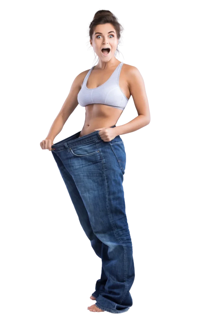Excited woman showing weight loss results by holding oversized jeans after medical weight loss program